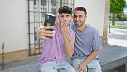 Two men couple smiling confident having video call at street