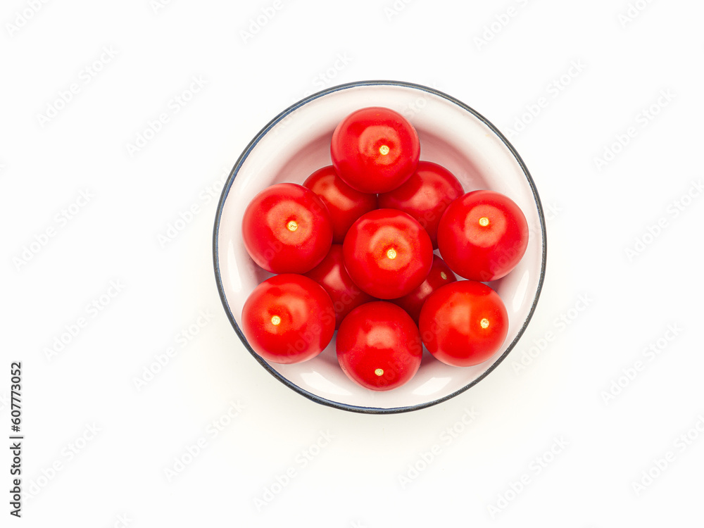 A pile of rotten tomatoes is on a bowl over a white background. A pile of rotten tomatoes is on a bowl over a white background.
