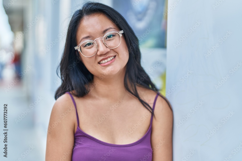 Young chinese woman smiling confident standing at street Young chinese woman smiling confident standing at street