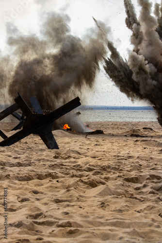 Background. Bombs exploding on the beach. Reconstruction of battle from the Second World War. photo