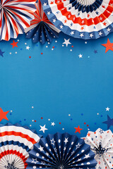 American Independence Day Party concept. Top view flat lay of folding fans in national colors, blue, red, white stars on blue background with empty space for text or advert