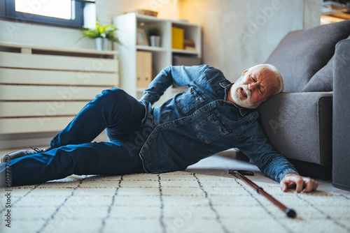 Senior man falling on the ground with walker in living room at home. Elderly older mature male having an accident headache for emergency help support from hospital. Insurance health care © Dragana Gordic