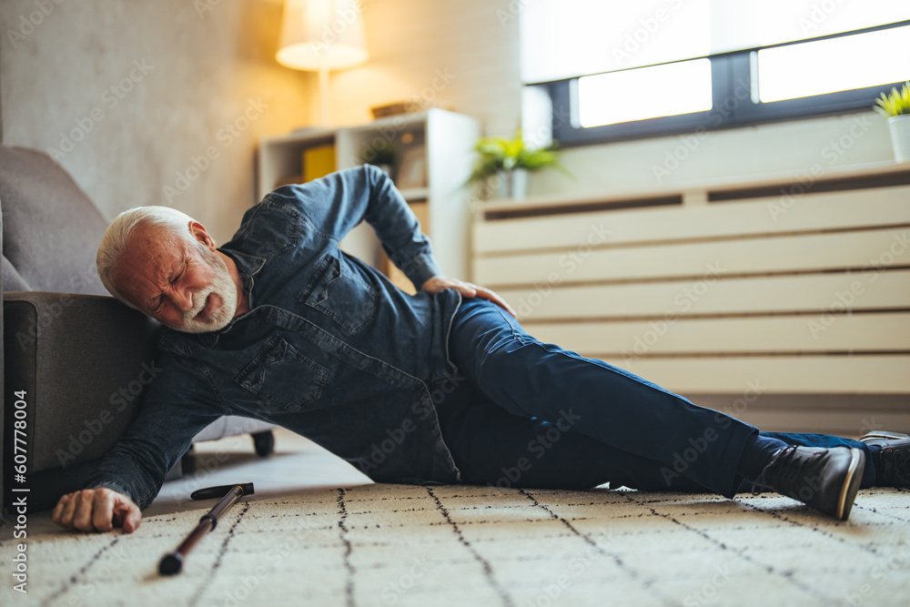 Sick senior old man falling down lying on the ground because stumbled at home alone with wooden walking stick in living room, elderly man grandfather having accident while walk with cane walker Sick senior old man falling down lying on the ground because stumbled at home alone with wooden walking stick in living room, elderly man grandfather having accident while walk with cane walker
