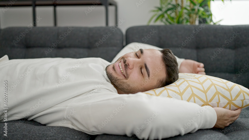 Young hispanic man lying on sofa sleeping at home Young hispanic man lying on sofa sleeping at home