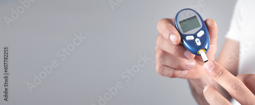Photography Man measuring glucose level at home.