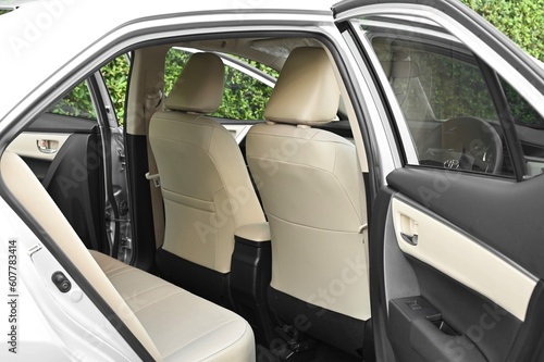 The rear passenger seat is wide and clean. Leather interior, side view, solar sunroof, buttons, Nappa leather, beige,black