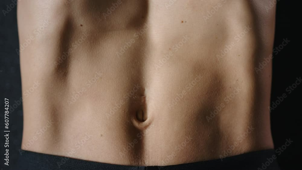 athletic young woman in black sportswear training abs on a black floor, close up. slow motion. top view. High quality 4k footage athletic young woman in black sportswear training abs on a black floor, close up. slow motion. top view. High quality 4k footage