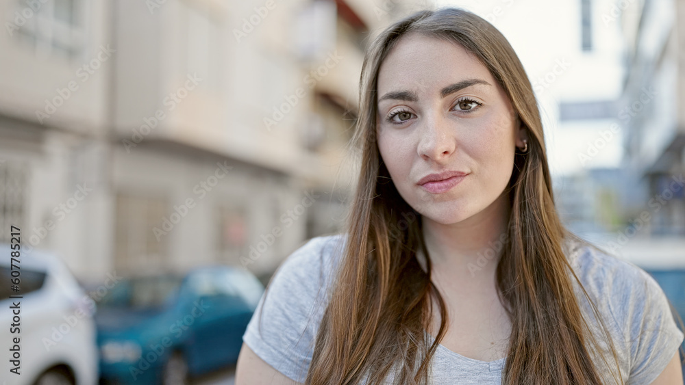 Young beautiful hispanic woman standing with relaxed expression at street Young beautiful hispanic woman standing with relaxed expression at street
