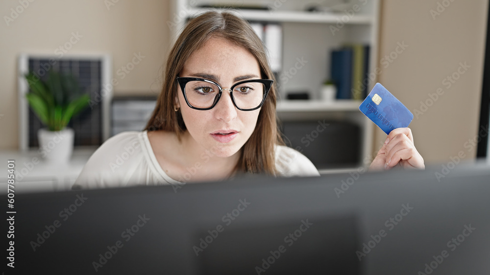 Young beautiful hispanic woman business worker using computer and credit card at office Young beautiful hispanic woman business worker using computer and credit card at office