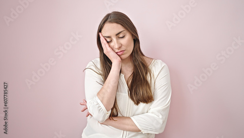 Young beautiful hispanic woman with boring expression standing over isolated pink background © Krakenimages.com