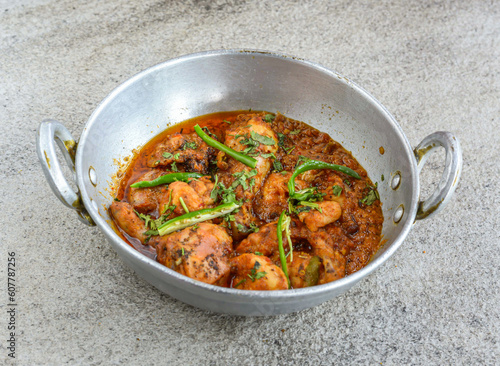 chicken karahi korma with gravy served in plate isolated on grey background top view of pakistani and indian spices food
