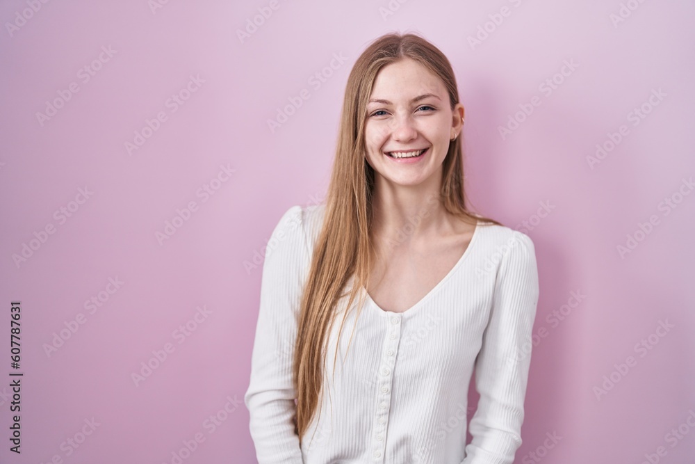 Young caucasian woman standing over pink background winking looking at the camera with sexy expression, cheerful and happy face. Young caucasian woman standing over pink background winking looking at the camera with sexy expression, cheerful and happy face.