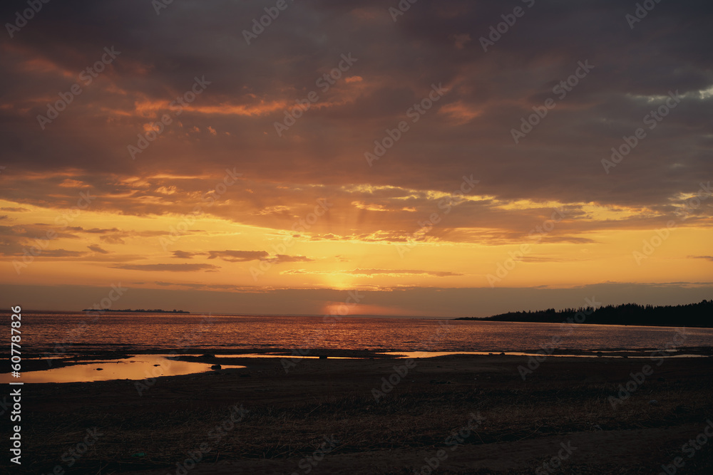 sunset above horizon over the sea. Beautiful cloudy evening sky. Abstract photo sunset above horizon over the sea. Beautiful cloudy evening sky. Abstract photo