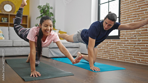 Man and woman couple training core exercise at home