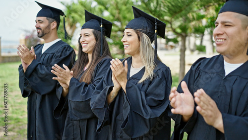 Group of people students graduated clapping applause at university campus