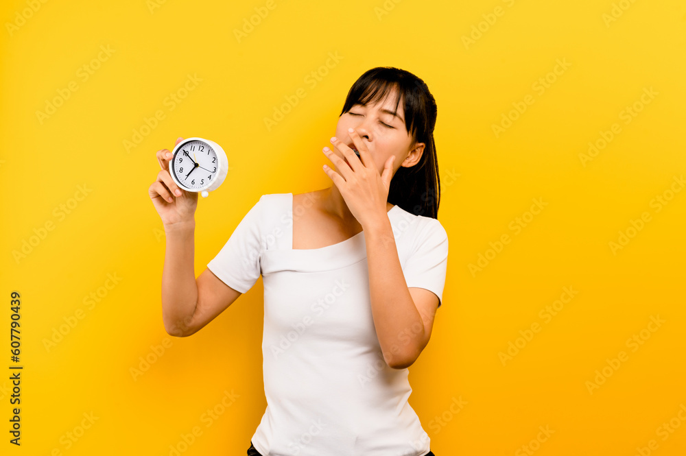 Bed time, rest time, sleepy, sleep on time, the importance of sleep and relaxation Young female hand holding a watch and showing sleepiness Bed time, rest time, sleepy, sleep on time, the importance of sleep and relaxation Young female hand holding a watch and showing sleepiness
