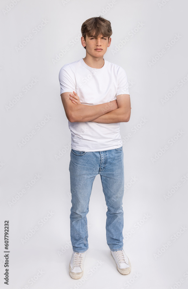 Handsome teenager teen male boy teen young adult wearing white t-shirt and jeans Handsome teenager teen male boy teen young adult wearing white t-shirt and jeans