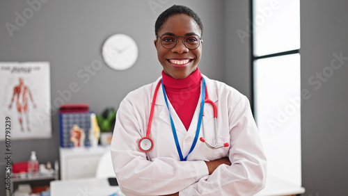 African american woman doctor smiling confident standing with arms crossed gesture at clinic