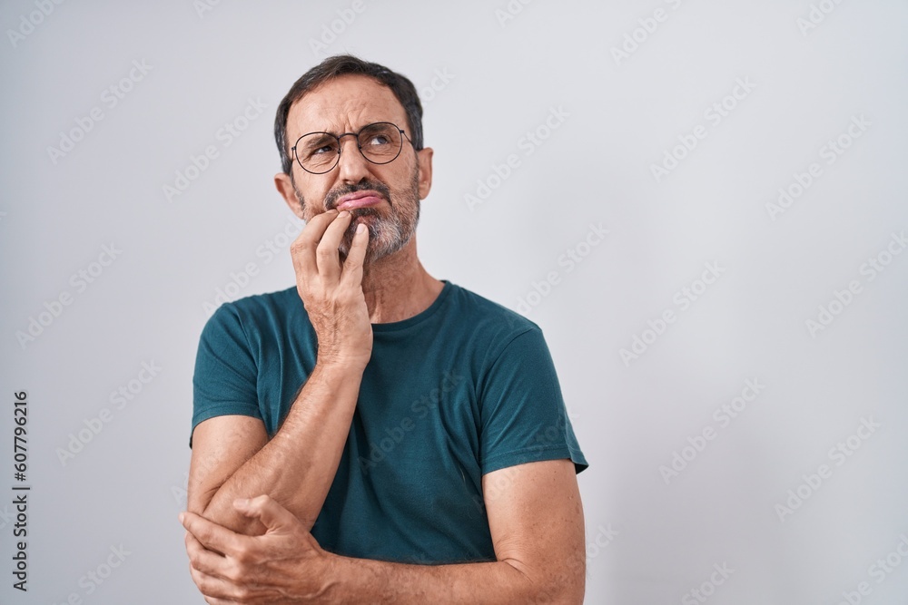 Fototapeta premium Middle age man standing with doubt expression over isolated white background