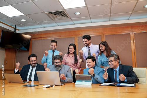 Indian businesspeople group celebrate after dealing feel happy and signing contract or agreement at meeting room
