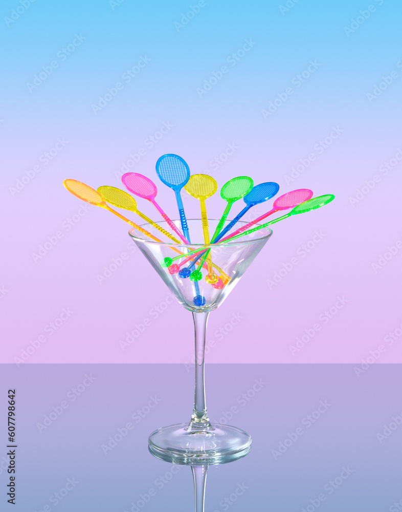 Sticks of different colors for cocktails in the form of rackets in a glass. Detail of cocktail party table.