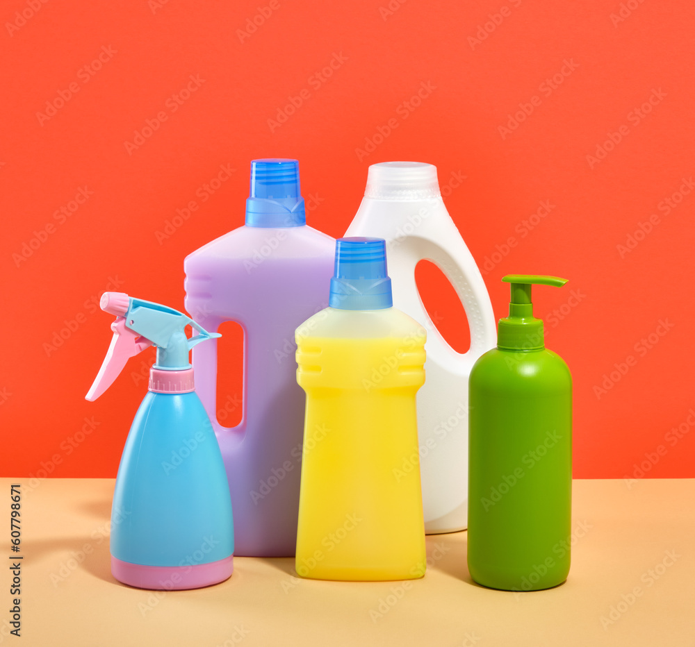 Cleanup and washing time. Bottles of yellow, purple and white with detergents and cleaners. Water spraying bottle for cleaning windows and mirrors. Cleanup and washing time. Bottles of yellow, purple and white with detergents and cleaners. Water spraying bottle for cleaning windows and mirrors.