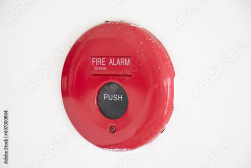 red fire alam on the white wall with copyspace background