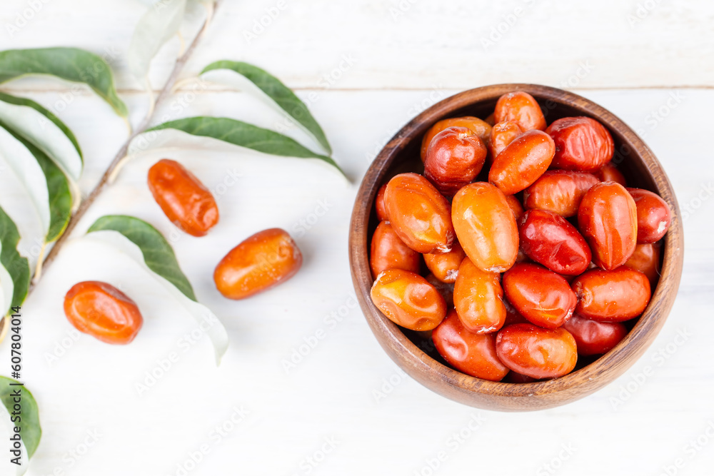 Fresh raw silverberry fruits in bowl with bunch of silverberry tree, oleaster or russian olive ( Elaeagnus ) Fresh raw silverberry fruits in bowl with bunch of silverberry tree, oleaster or russian olive ( Elaeagnus )