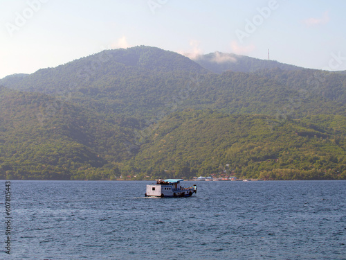An inter-island ferry in Indonesia is sailing from the port of Larantuka to the port of Maumere.