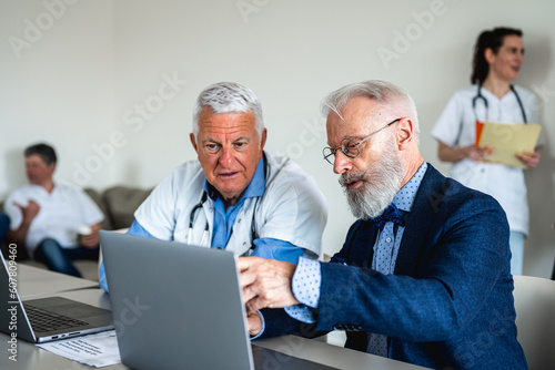 Time of technical meeting in a medical clinic between two experienced doctors and medical luminaries, consults on future operations and scheduled interventions