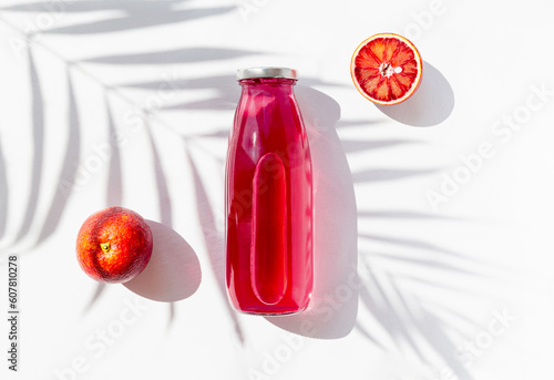 Wallpaper Mural Creative still life flat lay made of a bottle with homemade citrus kombucha on white background with palm tree leaf shadow and blood orange fruit. Minimal style. Healthy beverege concept Torontodigital.ca