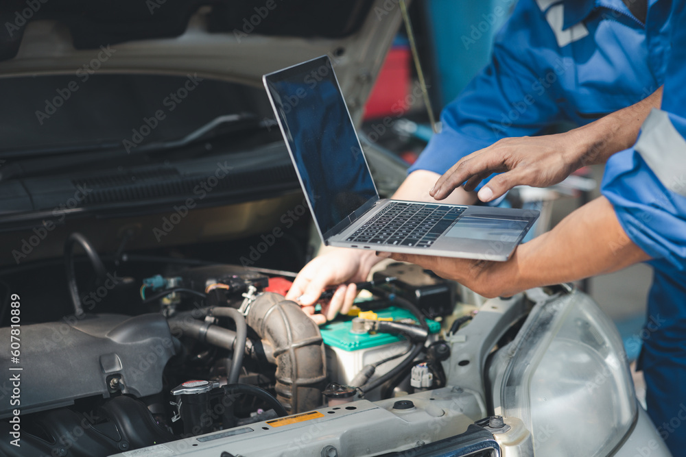 Two professional car mechanics are helping to inspect a customer's car being brought in for repair, all types of auto specialists, expert car repairs and certified auto repair centers. Two professional car mechanics are helping to inspect a customer's car being brought in for repair, all types of auto specialists, expert car repairs and certified auto repair centers.
