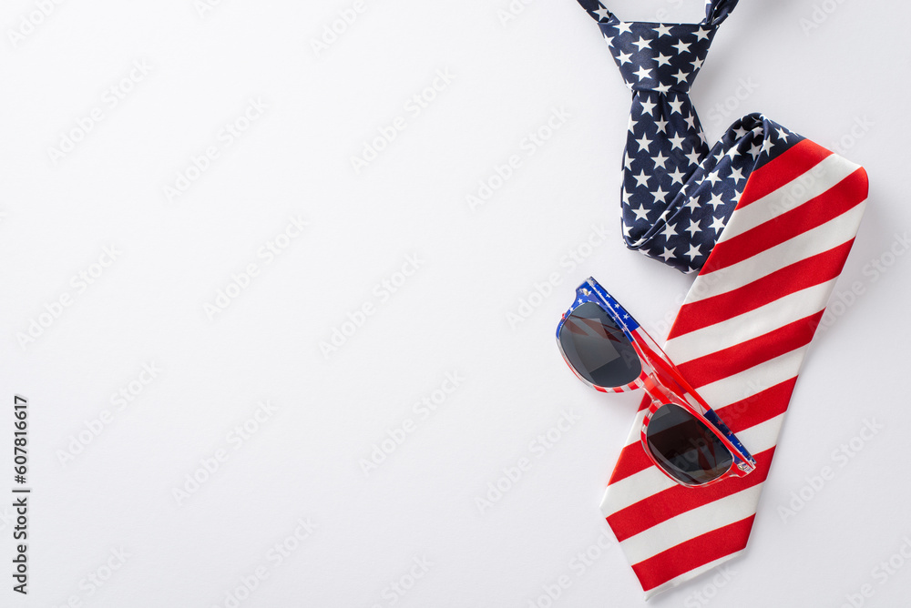Obraz premium Festive Fourth of July display featuring party essentials: top view of party eyeglases and necktie with U.S. flag pattern on a white background with space for text or promotion