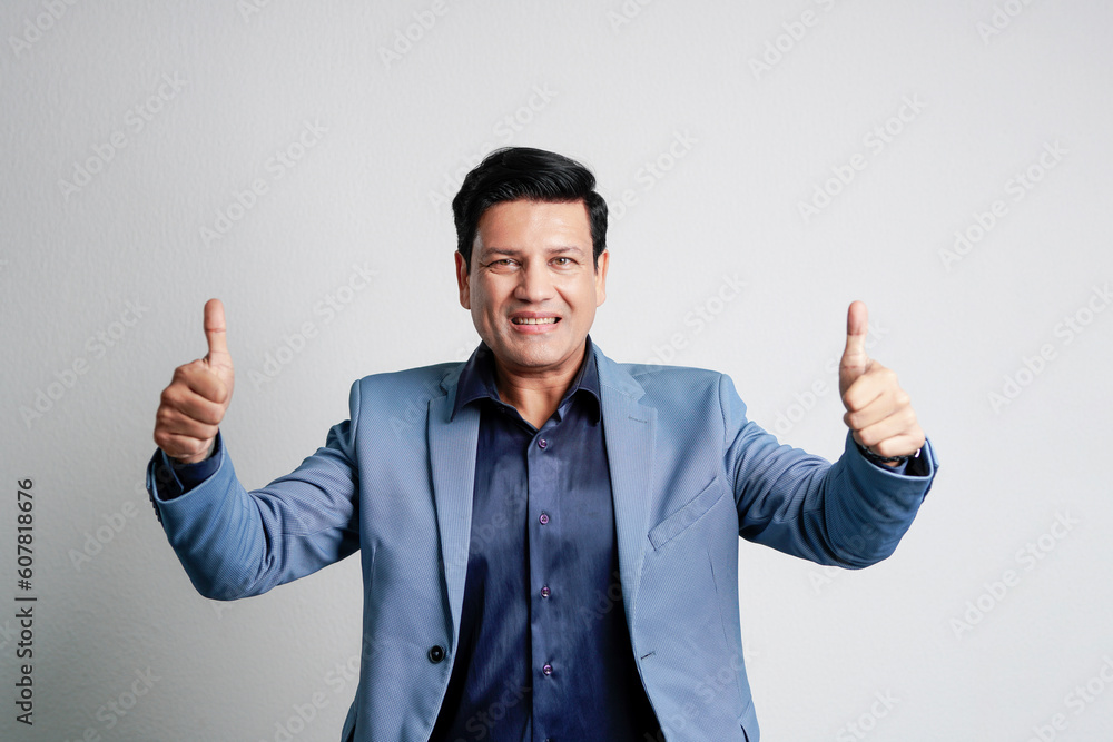 Indian businessman showing thumps up Indian businessman showing thumps up