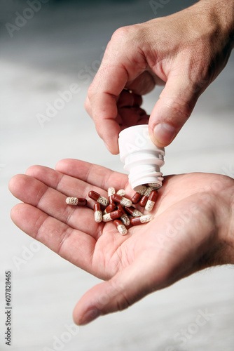 pills in the hands of the patient men