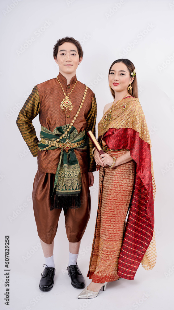 Asian couple in traditional thai costume smiling isolated on white background, Thailand traditional culture