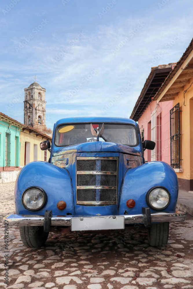 Old car inside a colorful Cuban Town