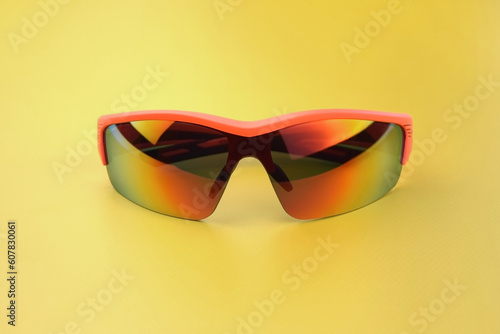 Sports goggles made of orange plastic with yellow lenses.