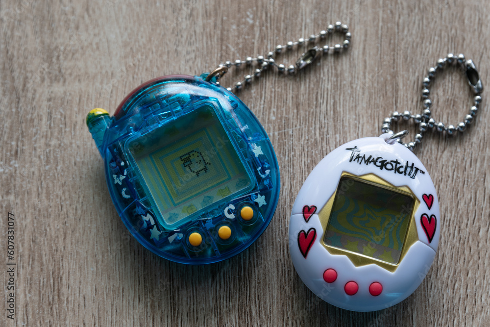 Naklejka premium Two Tamagotchi Virtual Pets on the table