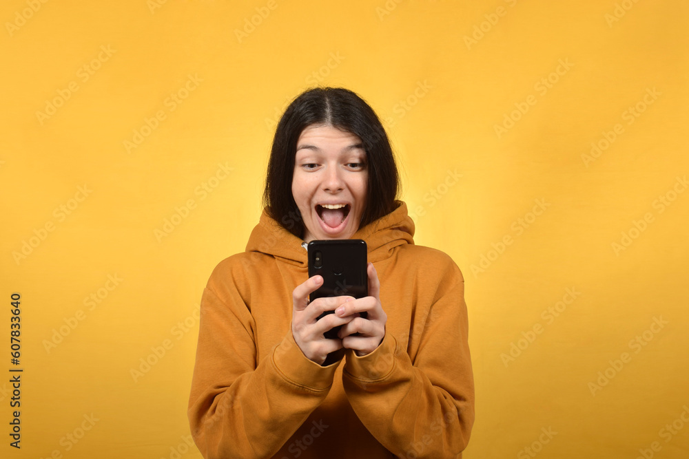 happy young brunette woman doing online shopping on smartphone happy young brunette woman doing online shopping on smartphone