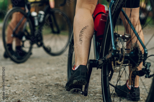 Unrecognizable woman cyclist having a bicycle chain mark on the leg