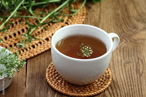 Herbal tea from herb Capsella bursa-pastoris  also known as  shepherd s purse. Herbal tea  used in traditional medicine  homeopathy and cosmetics.  Fresh  plant of shepherd s purse  wooden table.