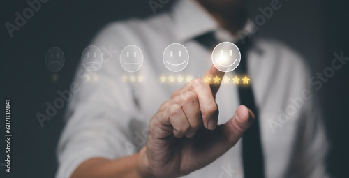 Businessman pressing emoticon smiley face on virtual screen. Customer service, review, feedback and rating concept.
