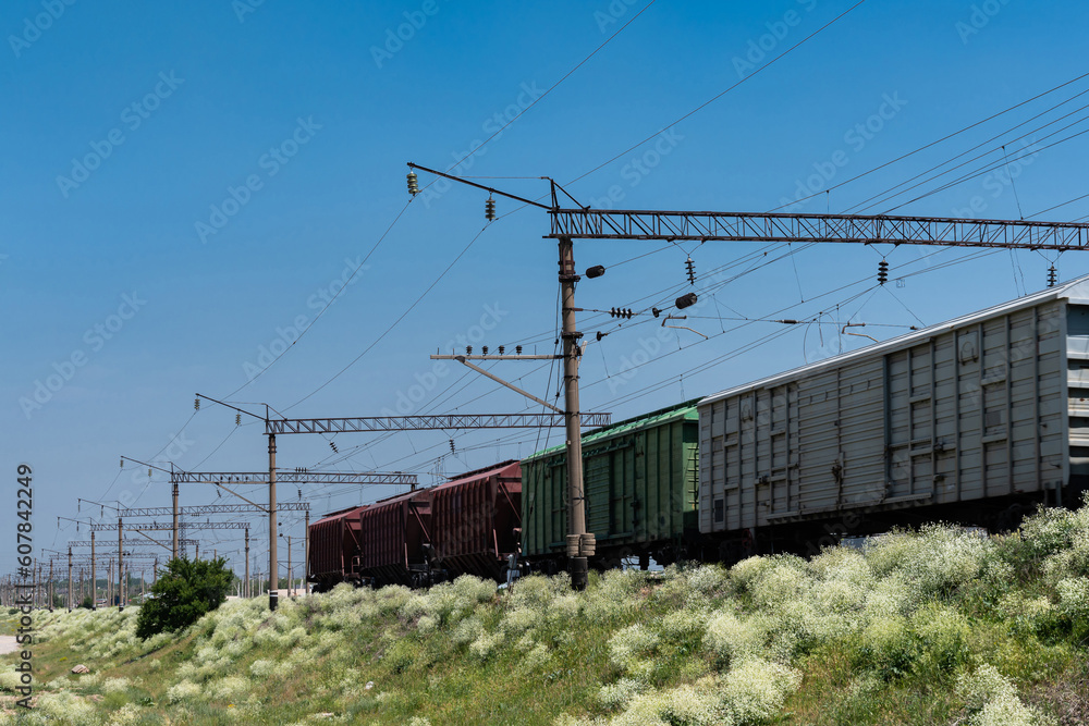 View of the railroad track with rolling cars falling. Clear blue sky. View of the railroad track with rolling cars falling. Clear blue sky.