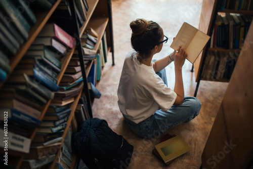 A student stuying and reading books in a public library. photo