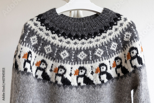 Icelandic wool Puffin lopapeysa sweater, grey knitted pullover large yoke in traditional Nordic knitting pattern close up photo