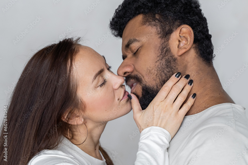 Multiethnic couple looking to each other over grey background. Black man and caucasian woman love sex relationship Multiethnic couple looking to each other over grey background. Black man and caucasian woman love sex relationship