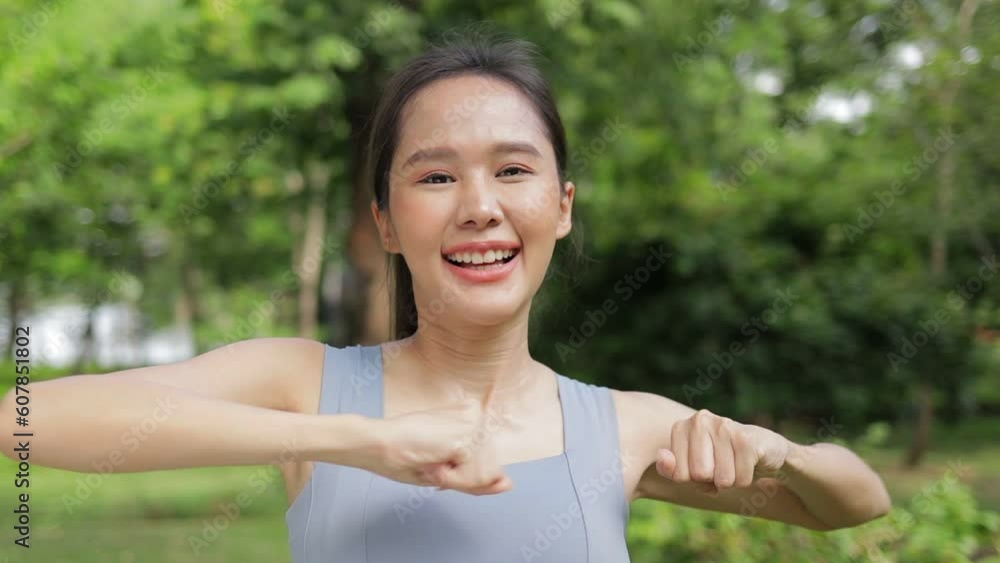 Portrait of young asian woman exercising outdoors in park She smiles bright and happy. Sport concept, health care Portrait of young asian woman exercising outdoors in park She smiles bright and happy. Sport concept, health care