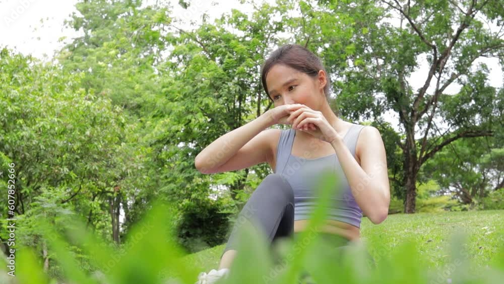 Asian woman exercising outdoors in the park She is applying sunscreen. health care concept Asian woman exercising outdoors in the park She is applying sunscreen. health care concept