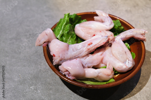 close up a plate of uncooked bullfrog meat. Raw food ingredient 